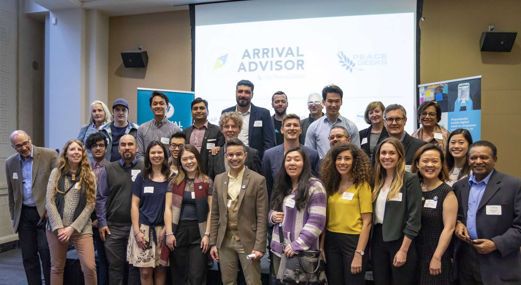 Photo from our Arrival Advisor launch event with several members of our advisory committees, including settlement organization staff and newcomers, who were instrumental in grounding and guiding our work